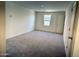 A newly constructed room with gray carpet; a bright and airy space with lots of natural light at 1984 E Bucking Bronco Dr, San Tan Valley, AZ 85140