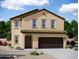 Charming two-story home with a stucco exterior, a tile roof, and a spacious two-car garage at 1984 E Bucking Bronco Dr, San Tan Valley, AZ 85140