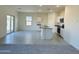 Open-concept kitchen and living area featuring white cabinets and stainless steel appliances at 1984 E Bucking Bronco Dr, San Tan Valley, AZ 85140