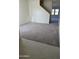 A brightly lit, new living room featuring soft gray carpet, and new tile at 1984 E Bucking Bronco Dr, San Tan Valley, AZ 85140