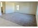 Spacious living room featuring new gray carpet, a window and natural light at 1984 E Bucking Bronco Dr, San Tan Valley, AZ 85140