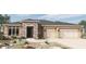 Charming single-story home featuring a three-car garage and an attractive stone facade entryway at 20237 W San Juan Ave, Litchfield Park, AZ 85340