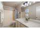 Bathroom featuring a vanity with a sink, a large mirror, and a shower-tub combo at 20501 N 93Rd Ave, Peoria, AZ 85382