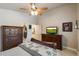 Spacious bedroom with wood furnishings, ceiling fan, and ample natural light at 20501 N 93Rd Ave, Peoria, AZ 85382