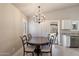 Elegant dining area with chandelier, neutral walls, and easy access to backyard at 20501 N 93Rd Ave, Peoria, AZ 85382