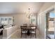 Bright dining area adjacent to kitchen, with patio access and wood-look floors at 20501 N 93Rd Ave, Peoria, AZ 85382
