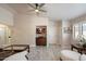Bright and airy living room with wood-look flooring, a ceiling fan and neutral decor at 20501 N 93Rd Ave, Peoria, AZ 85382
