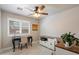This office has a ceiling fan, shuttered window, desk and work space at 20501 N 93Rd Ave, Peoria, AZ 85382