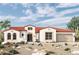 Charming single-story home with a red tile roof, neutral stucco, desert landscaping, and an attached two-car garage at 20793 W San Miguel Ave, Buckeye, AZ 85396