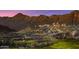 Scenic desert landscape with a home on a hill overlooking a golf course with desert mountains in the distance at 20793 W San Miguel Ave, Buckeye, AZ 85396
