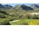 Scenic golf course view with lush green fairway, sand trap, and desert mountains in the background at 20793 W San Miguel Ave, Buckeye, AZ 85396