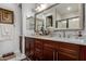 Bathroom boasts dual sinks, marble countertops, cherry cabinets, and tile floors at 20839 E Kingbird Dr, Queen Creek, AZ 85142