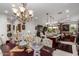 Elegant dining area showcasing a crystal chandelier, formal table setting, and a view into a well-appointed kitchen at 20839 E Kingbird Dr, Queen Creek, AZ 85142