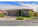 Charming home featuring a well-manicured lawn, mature shrubs, and a brick-paved driveway leading to a two-car garage at 20839 E Kingbird Dr, Queen Creek, AZ 85142