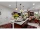 Spacious kitchen island with seating, open to living area, features modern appliances and connects seamlessly to the dining space at 20839 E Kingbird Dr, Queen Creek, AZ 85142
