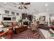 Open concept living space featuring modern decor, a large area rug, comfortable seating, and seamless access to kitchen and dining areas at 20839 E Kingbird Dr, Queen Creek, AZ 85142