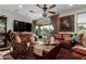 Inviting living room with stylish decor, comfortable leather seating, a large TV, and sliding doors to outdoor space at 20839 E Kingbird Dr, Queen Creek, AZ 85142