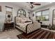 The main bedroom is spacious with a ceiling fan, neutral paint, carpet and large windows at 20839 E Kingbird Dr, Queen Creek, AZ 85142
