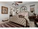 The main bedroom features an upholstered bedframe, ceiling fan and natural light at 20839 E Kingbird Dr, Queen Creek, AZ 85142