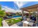 Outdoor pool area with lush foliage, patio seating, turf accents and privacy at 20839 E Kingbird Dr, Queen Creek, AZ 85142