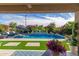 Beautiful backyard pool with mature flowering shrubbery, manicured lawn and outdoor furniture at 20839 E Kingbird Dr, Queen Creek, AZ 85142