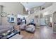 Bright, open-concept living space with wood floors, leading into kitchen and entryway with staircase at 21147 E Via Del Oro --, Queen Creek, AZ 85142