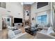 Spacious living room with a stone fireplace and comfortable seating arrangement, perfect for entertaining at 21147 E Via Del Oro --, Queen Creek, AZ 85142