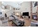 Expansive living room with high ceilings, a fireplace, and staircase leading to the second floor at 21147 E Via Del Oro --, Queen Creek, AZ 85142