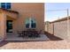 Cozy backyard patio with an outdoor dining area, complemented by rock ground cover, and a view at 21412 W Hubbell St, Buckeye, AZ 85396
