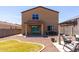 Expansive backyard view featuring a gazebo, lush green lawn, rock ground cover, and a covered patio at 21412 W Hubbell St, Buckeye, AZ 85396