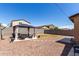 Spacious backyard featuring gravel ground cover, mature landscaping and a covered patio area perfect for entertaining at 21412 W Hubbell St, Buckeye, AZ 85396