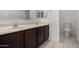 Bathroom featuring double sinks, modern fixtures, dark cabinets, a mirror, and a toilet at 21412 W Hubbell St, Buckeye, AZ 85396