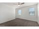 Bedroom with carpet, ceiling fan and two sunny windows at 21412 W Hubbell St, Buckeye, AZ 85396