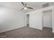 Bedroom featuring carpet, a ceiling fan, and a doorway to a hallway at 21412 W Hubbell St, Buckeye, AZ 85396