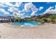 Relaxing community pool featuring plenty of seating, splash pad and mountain views at 21412 W Hubbell St, Buckeye, AZ 85396