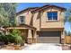 Charming two-story home features a tan stucco exterior and a two-car garage at 21412 W Hubbell St, Buckeye, AZ 85396
