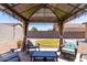 Gazebo in backyard featuring comfortable seating, stylish decor, and a relaxing outdoor ambiance at 21412 W Hubbell St, Buckeye, AZ 85396