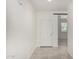 Bright hallway boasts neutral tile flooring leading to the main living areas at 21412 W Hubbell St, Buckeye, AZ 85396
