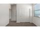 Hallway featuring a window and multiple doors at 21412 W Hubbell St, Buckeye, AZ 85396