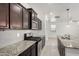 This kitchen features a gas range, stainless appliances, granite counters, and sleek, dark wood cabinets at 21412 W Hubbell St, Buckeye, AZ 85396