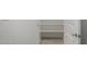 Walk-in pantry with tiled floors, shelving, and a bright white door at 21412 W Hubbell St, Buckeye, AZ 85396