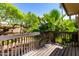Relaxing balcony with wooded railing overlooking a flowing stream and lush greenery at 2232 W Lindner Ave # 20, Mesa, AZ 85202