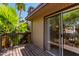 Cozy outdoor balcony with a sliding glass door and views of tropical plants and foliage at 2232 W Lindner Ave # 20, Mesa, AZ 85202