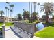 Charming walking bridge over the waterway with lush tropical landscaping in the community at 2232 W Lindner Ave # 20, Mesa, AZ 85202
