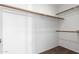 Spacious walk-in closet featuring wood closet rods and neutral carpeting at 2232 W Lindner Ave # 20, Mesa, AZ 85202