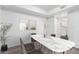 Bright dining room with stylish marble table, modern décor, and a view into the kitchen at 2232 W Lindner Ave # 20, Mesa, AZ 85202