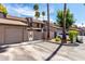 Inviting townhome exterior featuring a private garage, gated courtyard entry, and mature trees at 2232 W Lindner Ave # 20, Mesa, AZ 85202