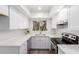 Bright white kitchen features stainless steel appliances, lots of cabinets and lighting at 2232 W Lindner Ave # 20, Mesa, AZ 85202