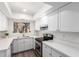 Bright renovated kitchen has white cabinets, light countertops, and stainless appliances at 2232 W Lindner Ave # 20, Mesa, AZ 85202