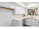 Updated kitchen has white cabinets and countertops and stainless dishwasher at 2232 W Lindner Ave # 20, Mesa, AZ 85202